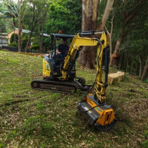 Yellow FEMAC T9 Excavator Mulcher on Yanmar VIO35 clearing scrub and small bushes