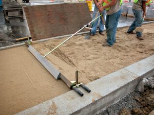 Probst EP-UNI hand screeding system being used for paving preparation