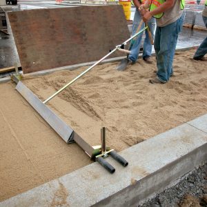 Probst EP-UNI hand screeding system being used for paving preparation