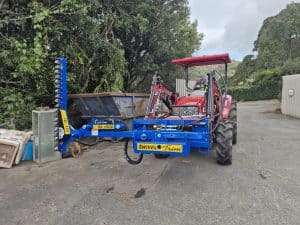 Case 60B small tractor fitted with Slanetrac SA1000 swivel trim hedge cutter attachment in Yellow Rock, NSW, Australia