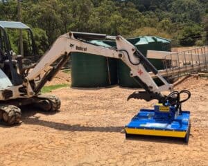 Slantrac FH100 Excavator slasher on 2.7T bobcat excavator in Australia. Used to clear invasive tea trees from property.