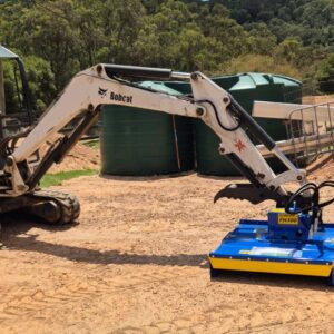 Slantrac FH100 Excavator slasher on 2.7T bobcat excavator in Australia. Used to clear invasive tea trees from property.